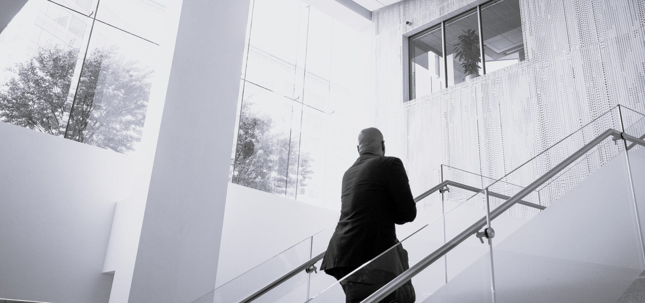 Man walking up stairs in School of Continuing Studies