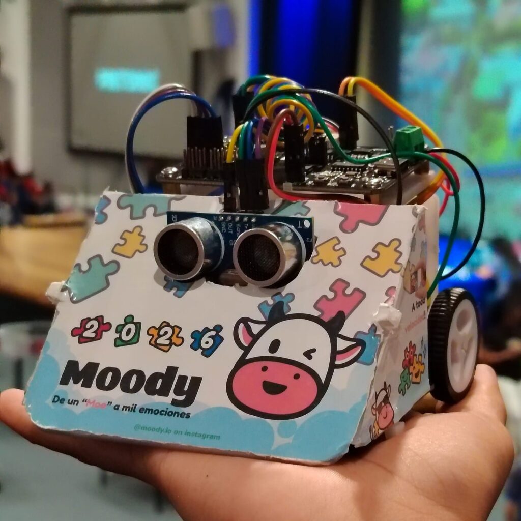 A close-up view of the educational Sumobot robot model, customized with visual graphics and branding from the Moody communication app.